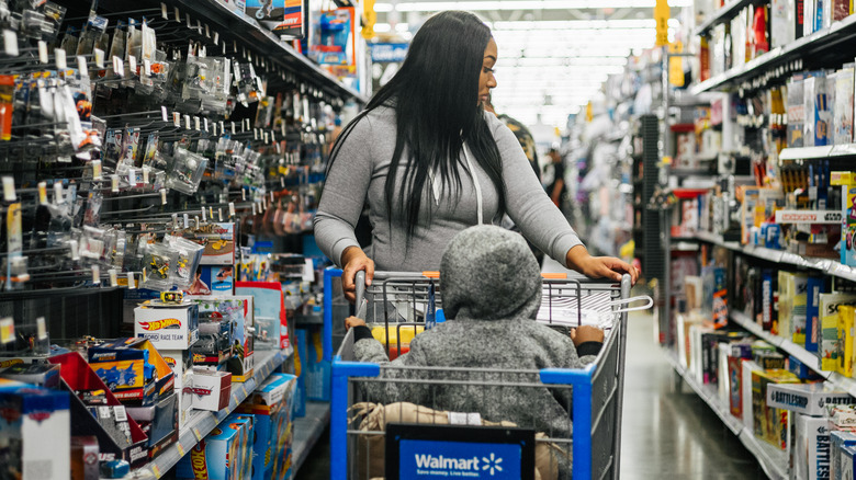 Shopping cart with boxes in front of Walmart logo