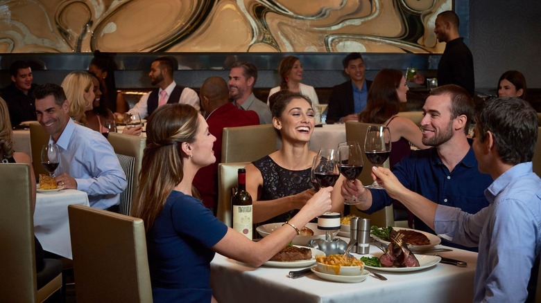 Smiling people dining at tables