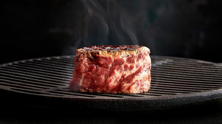 Steak sizzling on grill