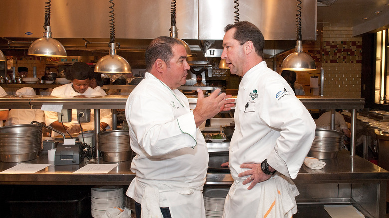 Emeril Lagasse talking to another chef