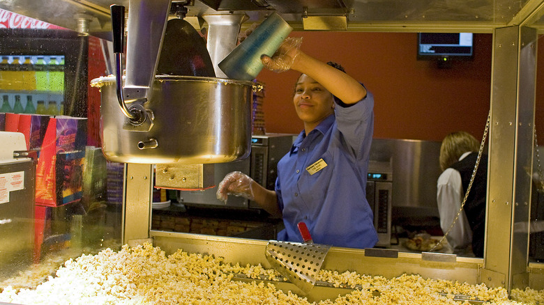 Attendant working at a popcorn concession stand