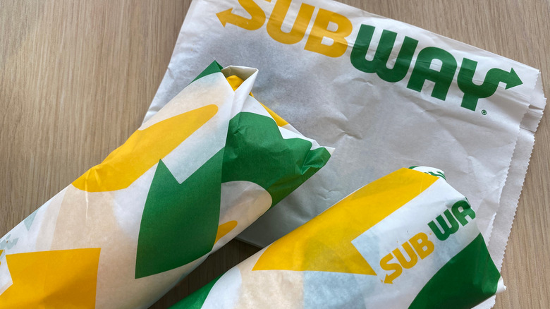 Wrapped Subway sandwiches with bag