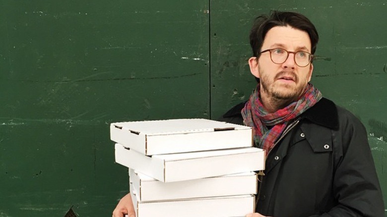 Peter Meehan holding pizza boxes