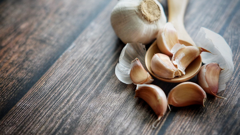 Garlic cloves on a wooden background