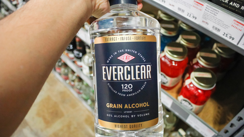 person holding Everclear bottle