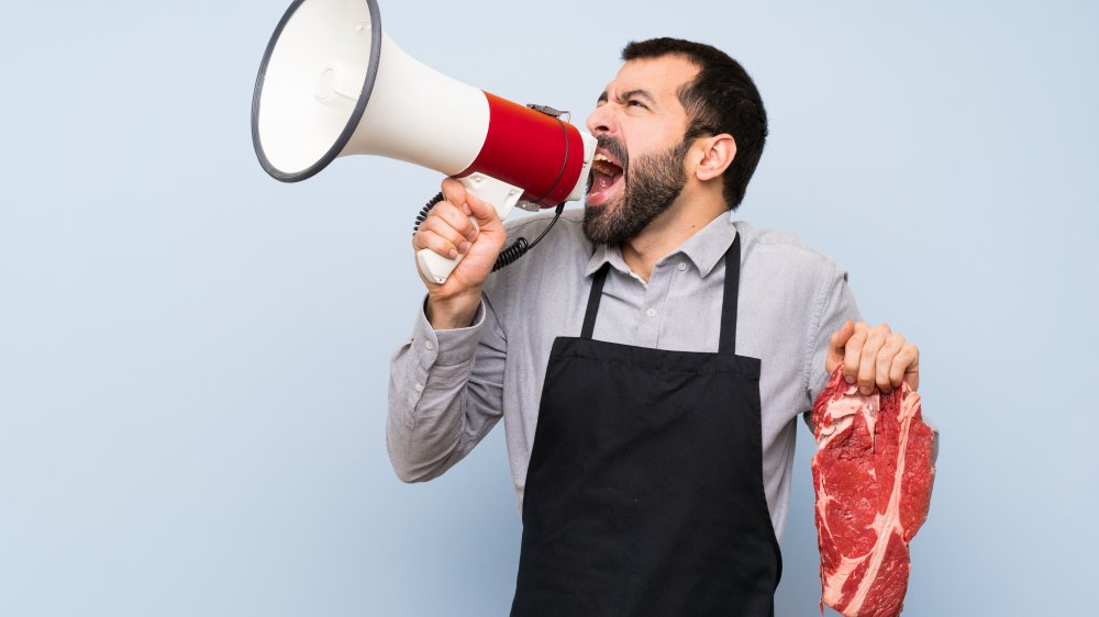 Man with steak and bull horn 