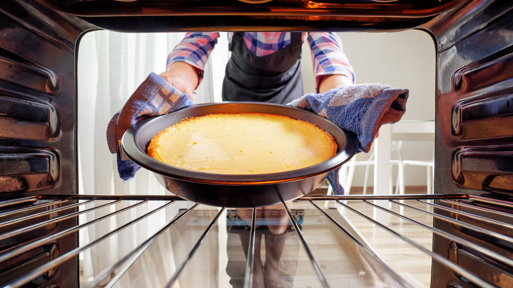 Taking cake out of the oven