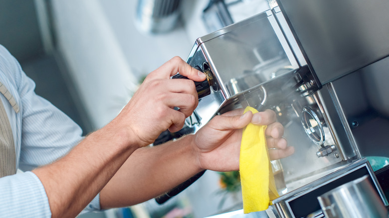 Person cleaning coffee maker