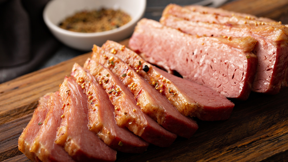 Sliced corned beef on cutting board