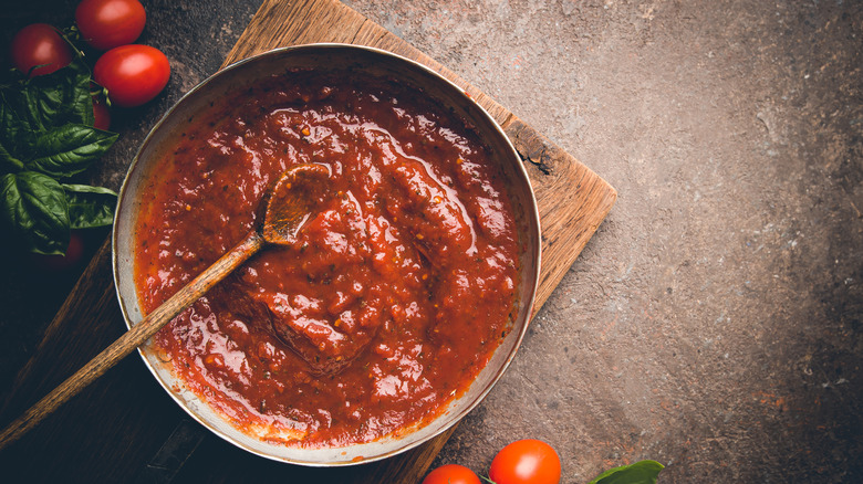 Pasta sauce with a wooden spoon