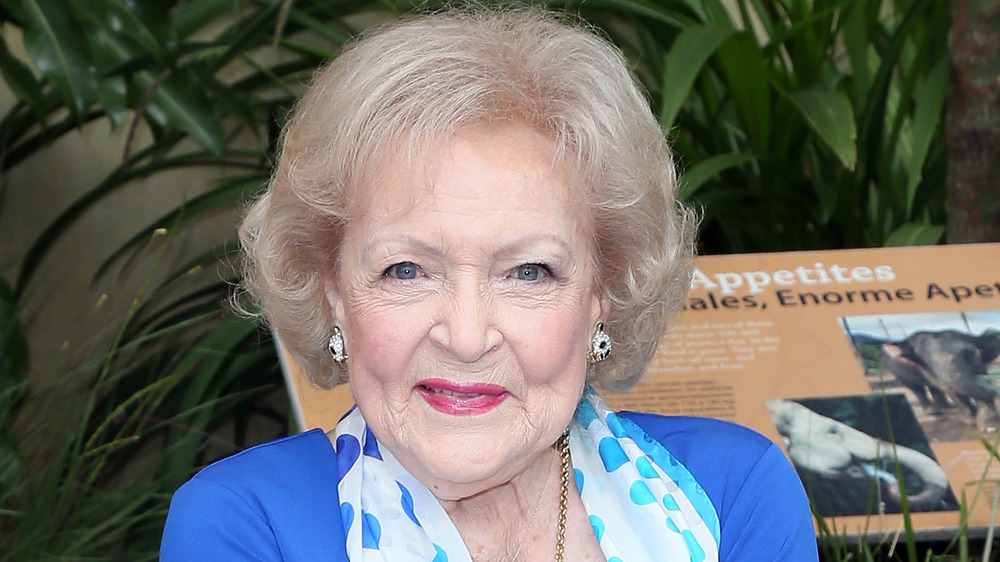 Betty White earring a blue top and polka dot scarf