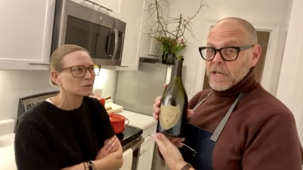 Alton Brown holds bottle of Dom Perignon on QQ