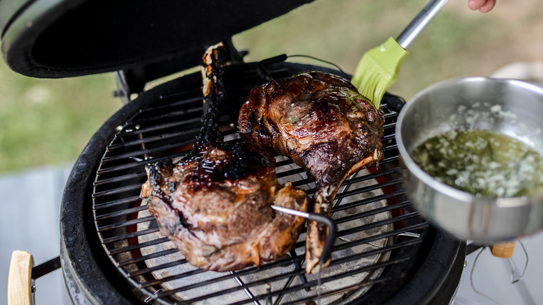 Dry-aged grilled tomahawk steak on grill