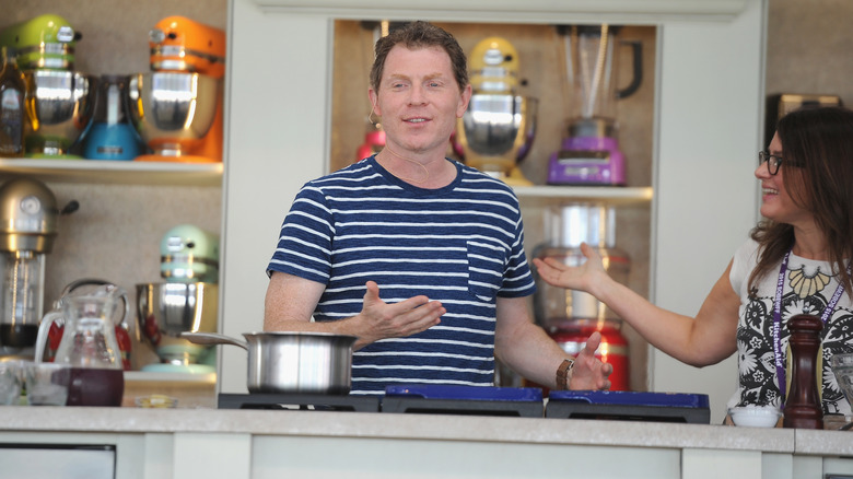 Bobby Flay in the kitchen in striped shirt