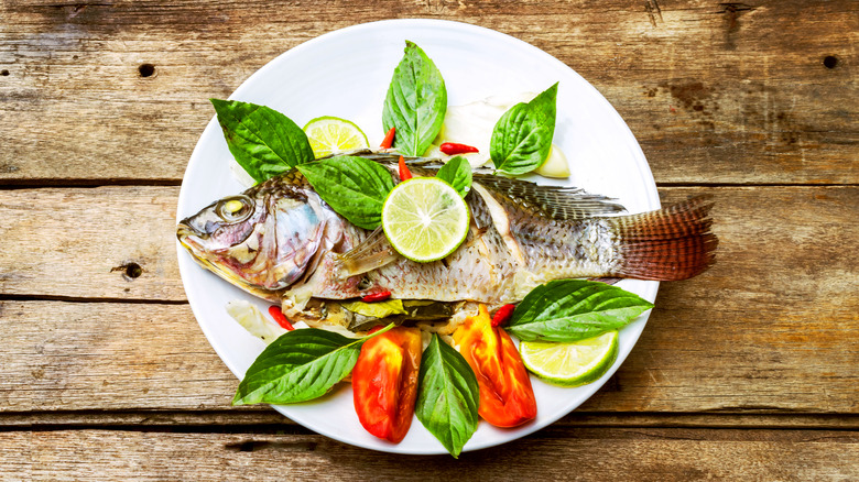 A whole steamed fish in a plate