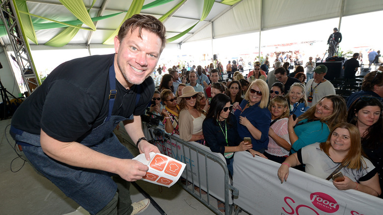 Tyler Florence posing with fans 