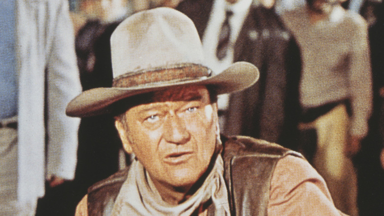 John Wayne wearing cowboy hat and looking into camera