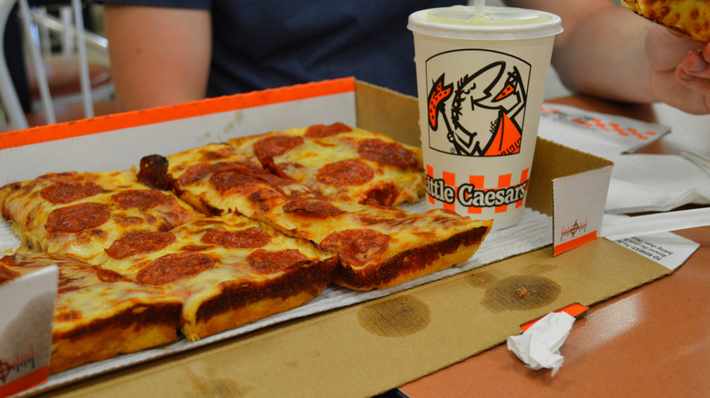 Little Caesars pizza and white cup