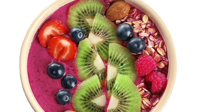 Smoothie topped with kiwi and raspberries