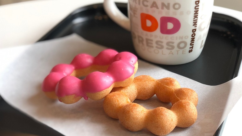 Dunkin' coffee cup with pink iced rings