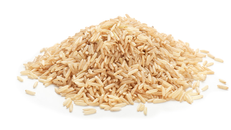 Pile of brown rice on white