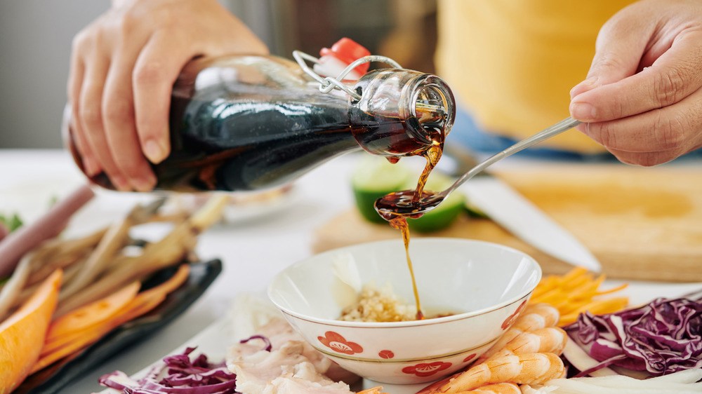 pouring soy sauce into bowl