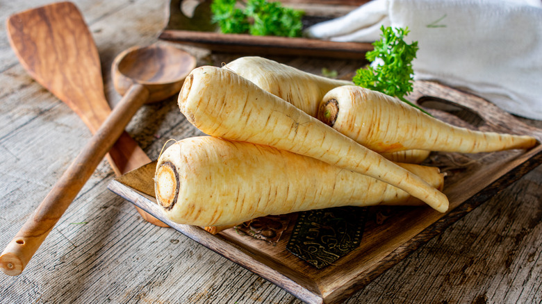 parsnips stacked on board