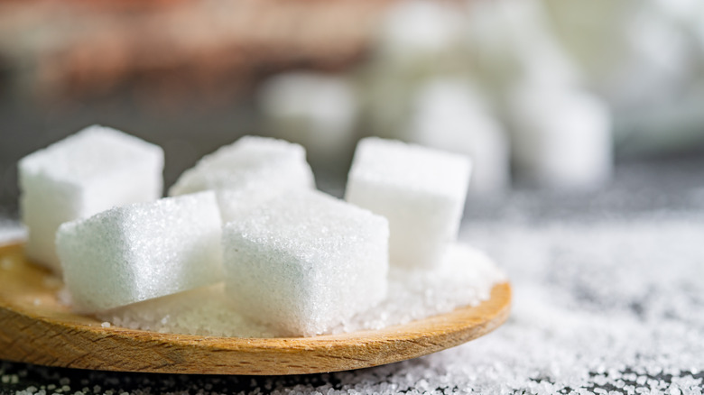 sugar cubes on wooden spoon