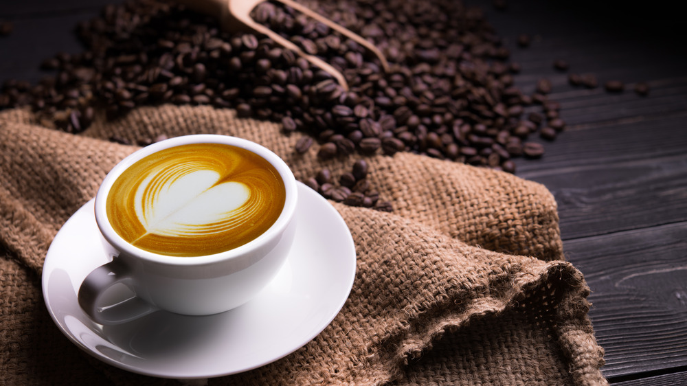 latte with coffee beans in background