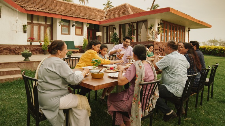 Indian family eating outside home