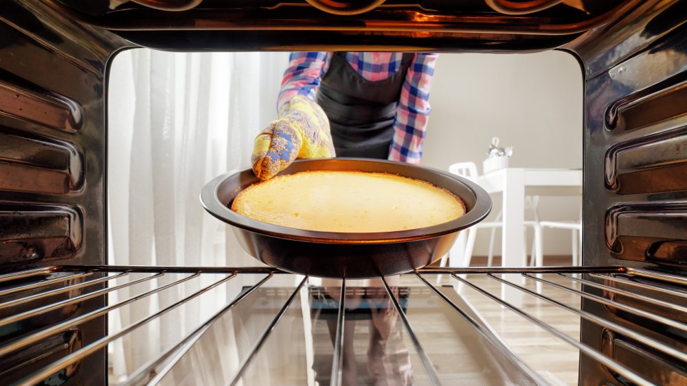 taking cheesecake out of the oven