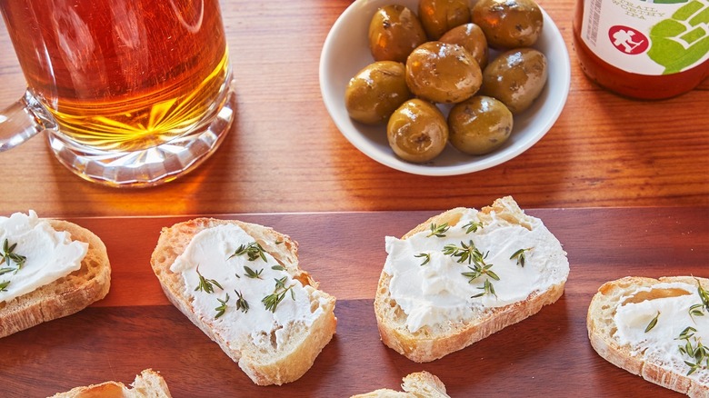 goat cheese on toast with beer and olives