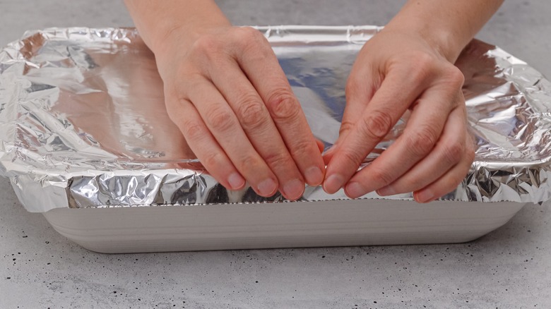 Woman covers baking dish