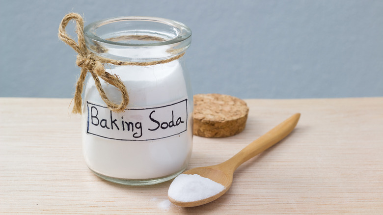 jar of baking soda with wooden spoon