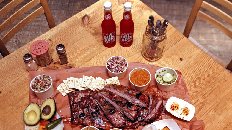 bottles of Big Red Soda and a platter of BBQ