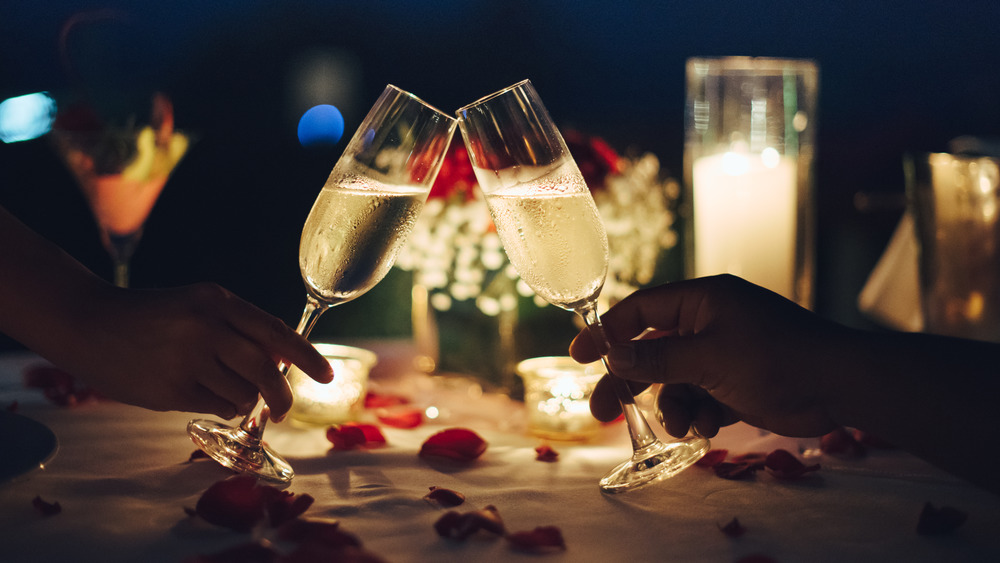 Couple toasting champagne at romantic dinner