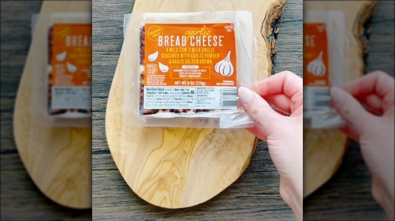 a package of cheese on a wooden board