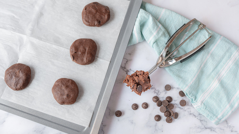 scooping cookie dough for rich double chocolate chip cookies