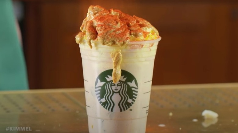 Yellow and red drink in Starbucks cup