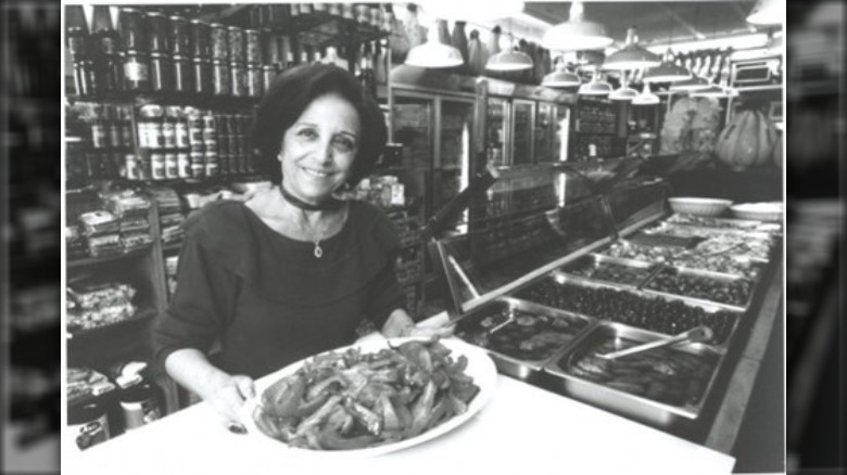 Mama Sbarro holding a platter of food