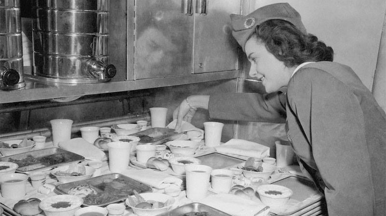 Pan Am flight attendant preparing plane meals