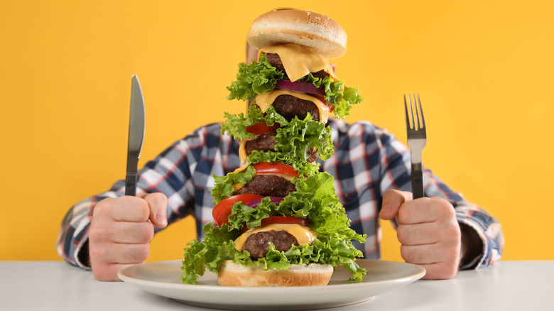 Man hidden behind giant burger