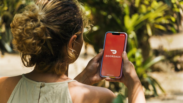 woman on doordash app on phone