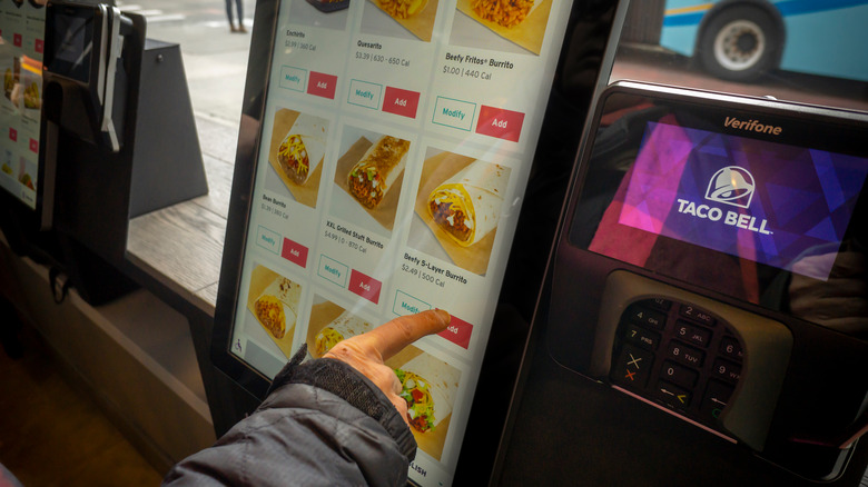 Person ordering Taco Bell using touchscreen