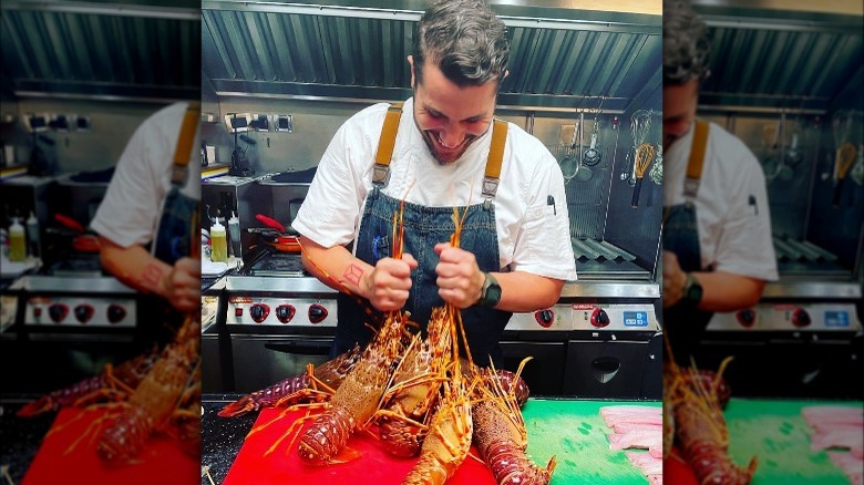 Chef Marcos Spaziani holds two lobsters