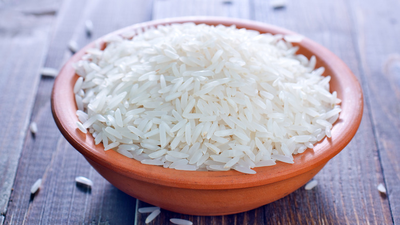 Rice in bowl on wood surface