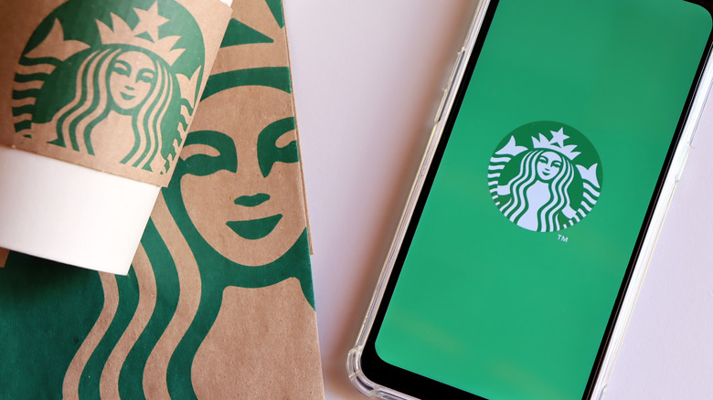 Starbucks cup next to smartphone on table