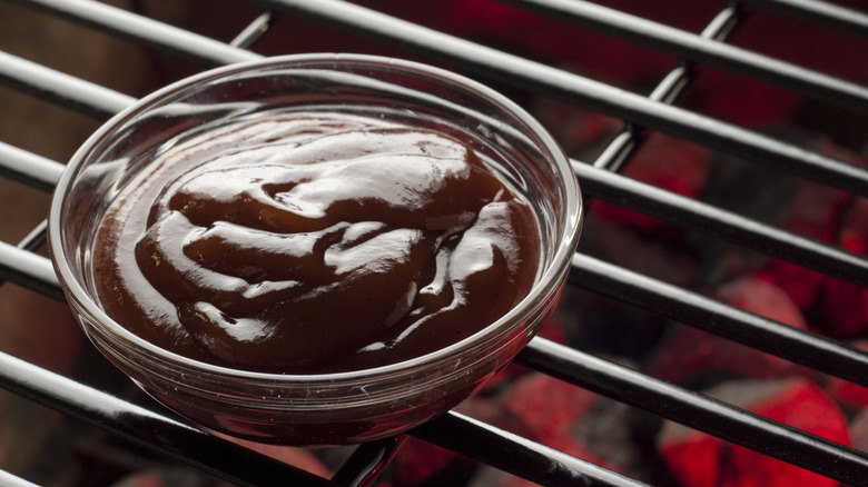 bowl of barbecue sauce over grill