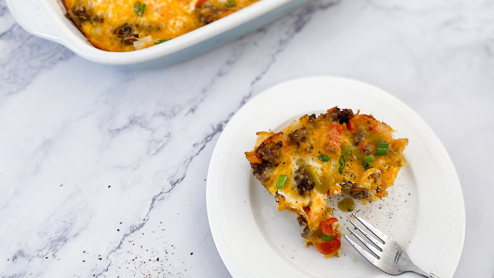 slice of sausage breakfast casserole on plate with fork