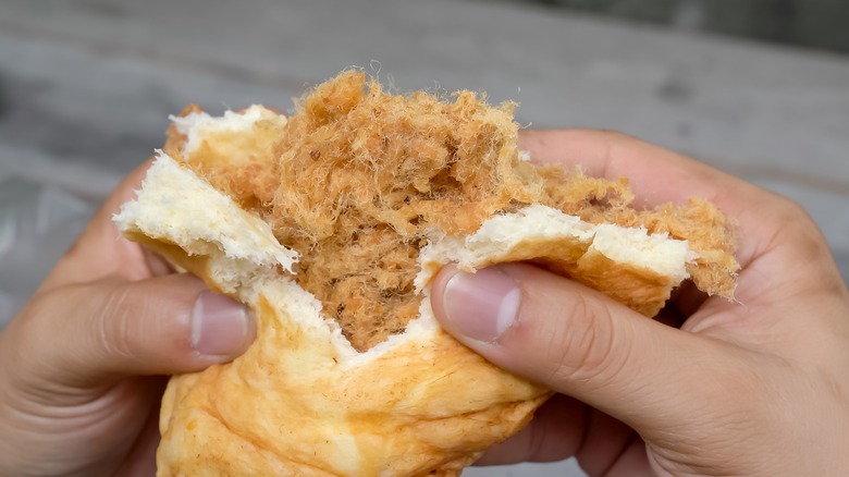 tearing open pork floss bun